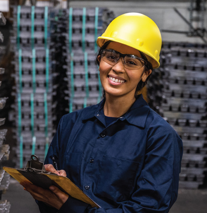 Lead battery recycling employee smiling