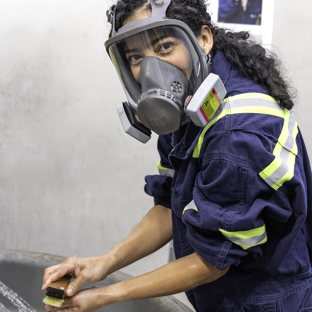 EHS employee washing her hands at a lead battery recycling facility.
