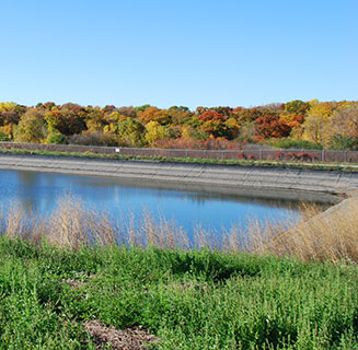 Storm water pond of a lead battery recycling facility demonstrating environmental stewardship and sustainability.