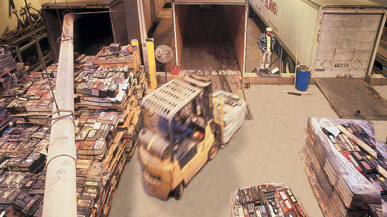 View of pallets of used lead batteries delivered to a lead battery recycling facility.