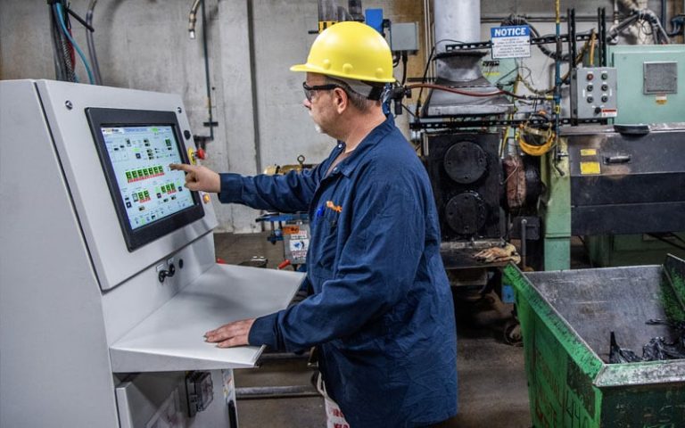 Lead battery manufacturing employee working on innovative control systems.