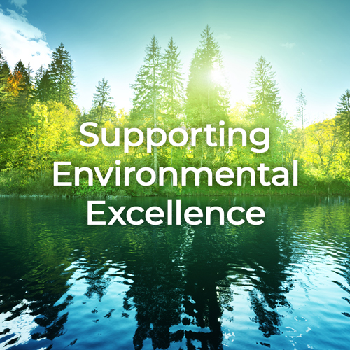 Evergreen trees, a lake and a blue sky with Supporting Environmental Excellence text.